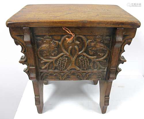 A 19th Century continental elm chest of small proportions, rising top, front and rear carved with