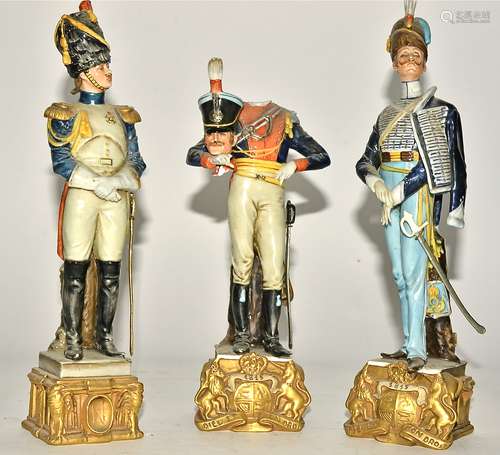 Three Capodimonte porcelain Continental soldiers, raised on square plinth with eagles, height 29.