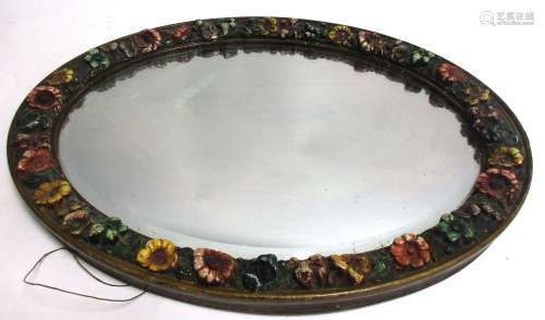 An early 20th Century oval mirror, with floral surround, 51cm x 41cm