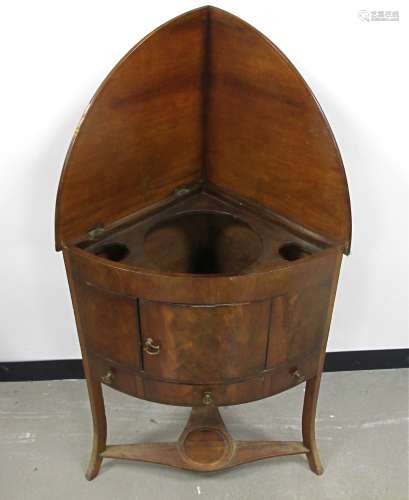 A Georgian mahogany corner washstand, hinged fold down top, platform with cut-outs for bowls,