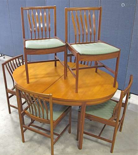 A mid-Century teak dining suit, possible Danish design, comprising an oval draw leaf table with fold