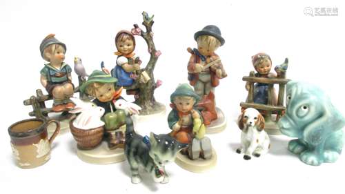 Six Goebel Hummel childhood ceramic figures, boy with rabbits 5870, boy and dog with violin, boy