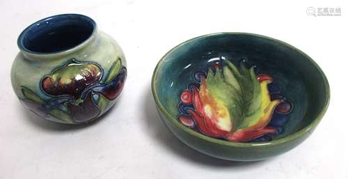 Two pieces of Moorcroft Pottery, one of globular form with tube lined iris, on a blue green