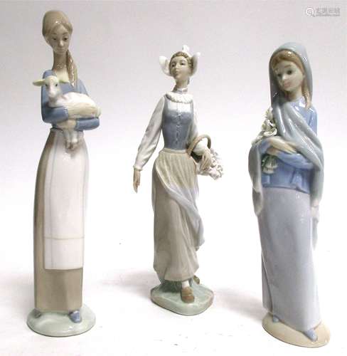 Three Lladro porcelain figures, girl and lamb, girl with basket of flowers and girl with lilies,