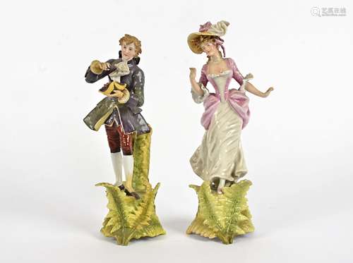 A pair of late 19th Century Volkstedt figures, modelled as a fashionable couple, height 26cm, male