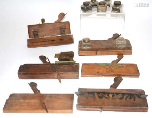 Six antique moulding planes, together with a small collection of writing slope inkwells, plus