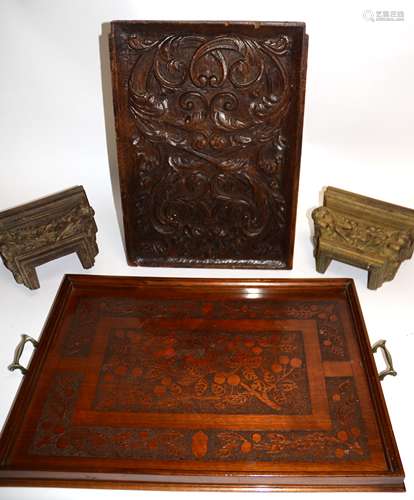 An early 20th Century oak twin handled tray with an embossed cherry and foliate design, together