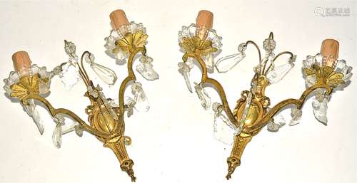 A pair of gilt metal and glass wall lights, each with two branches supporting floral bowls,