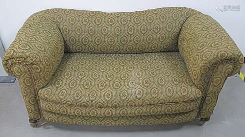 A late 19th Century two seater drop end Chesterfield settee, upholstered in a floral fabric with