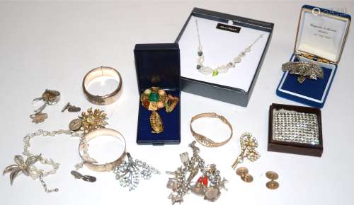 A pair of gold cufflinks, 8.3g, a silver heart chain-link charm bracelet with multiple objet d'art
