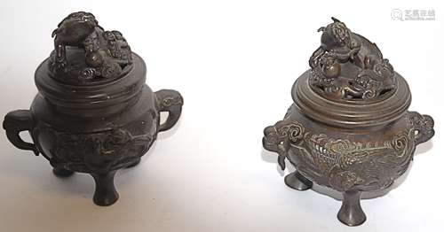 Two Chinese bronze koro, of footed circular form, cast in relief with panels of birds,