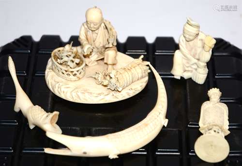 Two Meiji period Japanese ivory okimono figures, one a male figure crouching by a bundle of flower