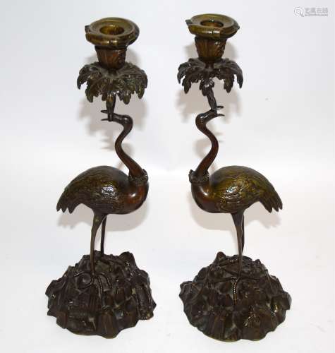 After Thomas Abbott, a pair of bronze figural candlestick holders, taking the form of cranes