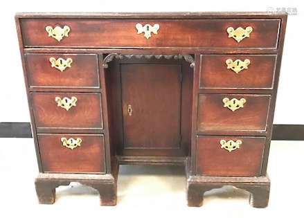 A Queen Anne Style kneehole desk, having single long drawer over central single cupboard, flanked by