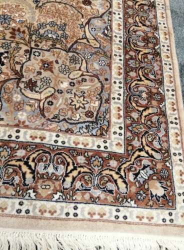 A 20th Century Nain Persian woollen rug, on an ivory field, with an all over profusion of flowers