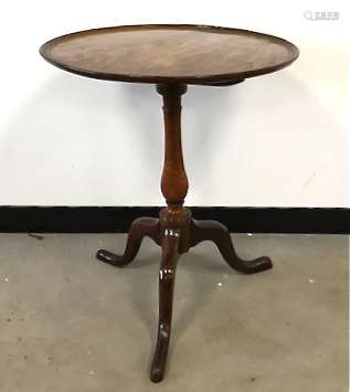 A George III period mahogany occasional tilt top table, moulded edge to circular top on tripod base,