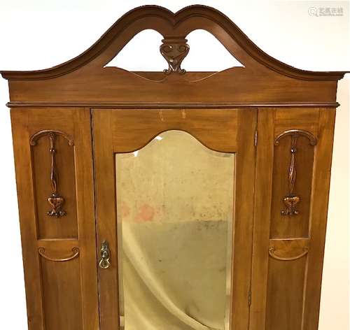 An Edwardian mahogany wardrobe, pierced cornice above single door with mirror with moulded flowers