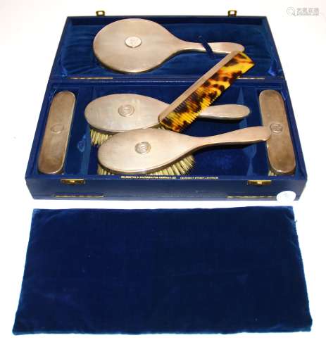 A George VI hallmarked silver dressing table set, London Maker, consisting of four brushes, one comb