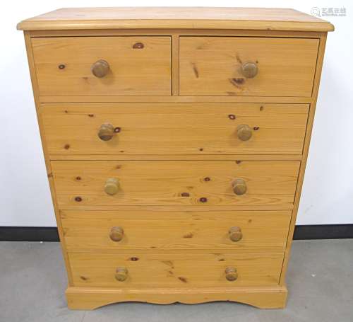 A contemporary Pine chest, with two short over three long drawers, moulded top, raised on a shaped