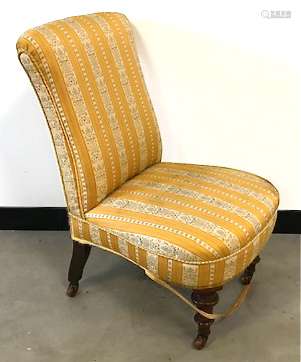 A Victorian nursing chair, with mahogany supports and neo-classical style upholstery