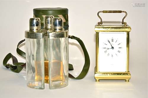 A three sectioned hip flask holder, the three inner bottles fitting together to a cylindrical shape,