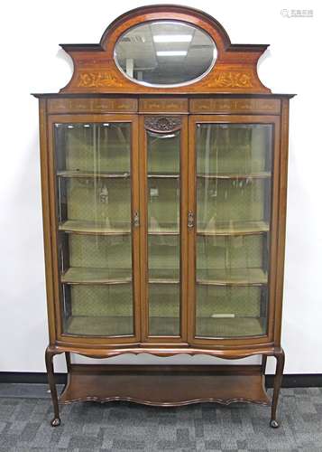 An Edwardian mahogany inlaid double doored display cabinet, with reverse serpentine front, boxwood