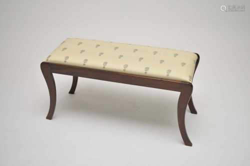 A mahogany framed stool with upholstered seat and sabre legs, 45cm high, 86 x 35cm.
