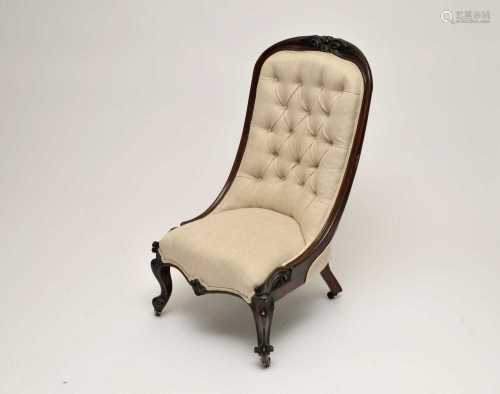 A Victorian mahogany framed spoon back chair, upholstered in a cream material, with buttoned back,