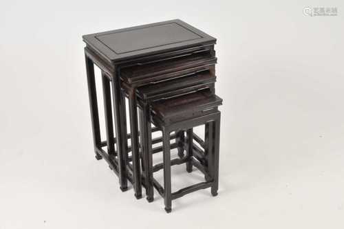 A graduating nest of four early 20th century Chinese hardwood occasional tables, the largest