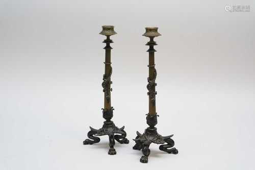 A decorative pair of early 20th century cast metal candlesticks, in the Aesthetic Movement manner,