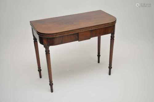 A 19th century mahogany fold-over tea table, with strung borders, raised on turned legs, 75cm