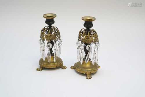 A pair of late 19th century French bronze and gilt metal candlesticks, decorated with hanging