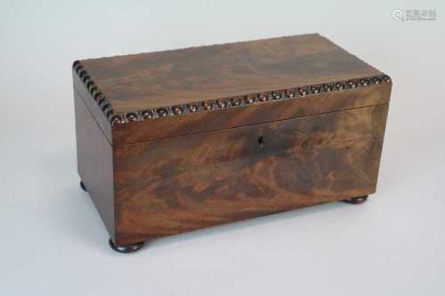 A 19th century mahogany tea caddy, of rectangular form, in flamed veneers, the hinged cover with