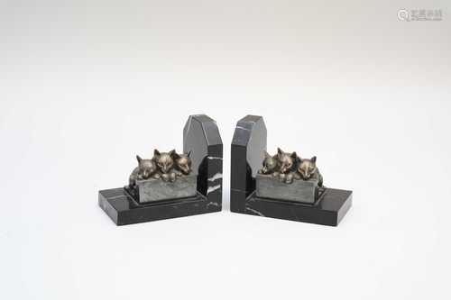 A decorative pair of French cast metal and polished marble bookends, with applied trios of seated