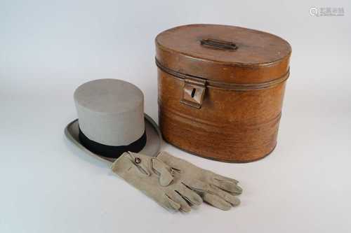 A scumbled tin hat box containing a grey Moss Bros top hat, size 6 7/8, together with a pair of