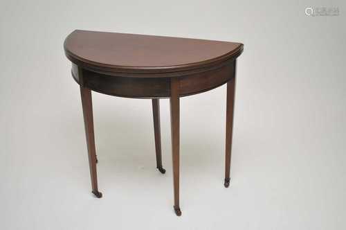 A demi-lune mahogany card table, 76 cm high, 84 x 42cm.