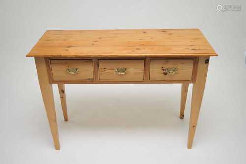 A pale pine side table, the planked top with a bevelled border, over three drawers, fitted with