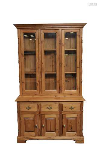 A modern pale pine dresser, of diminutive proportions, the enclosed top fitted with three glazed