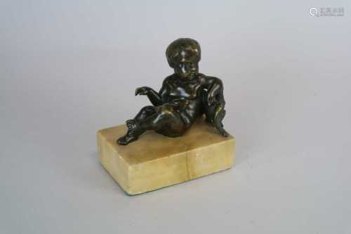 A small 19th century bronze study of a recumbant cherub with eagle, on a marble base, 11.5cm high,