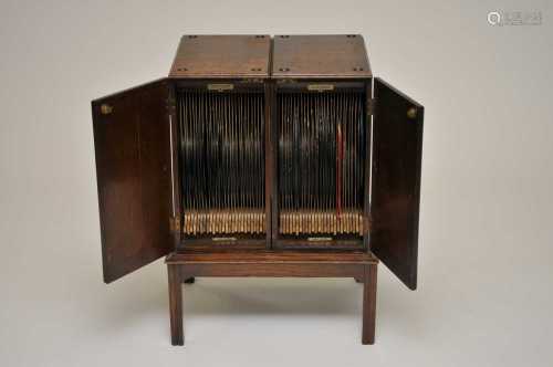 A two-sectional early 20th century oak 'Mellophone Record Cabinet', patent number 156966,