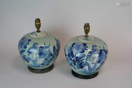 A decorative pair of blue and white desk lamps, hand-painted with birds and foliage in the Chinese