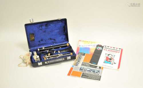 A cased Buffet Crampon clarinet, numbered 429634, together with student's learning guides.
