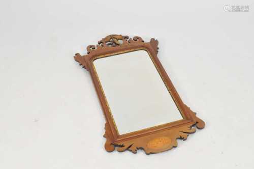 An Edwardian mahogany pier / wall mirror, the top with a pierced and carved Ho Ho bird pediment,
