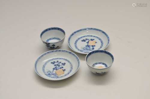 A pair of Nanking cargo miniature blue and white Chinese porcelain tea bowls and saucers, the