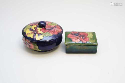 A Moorcroft circular jar and cover together with a rectangular trinket box and cover, each decorated