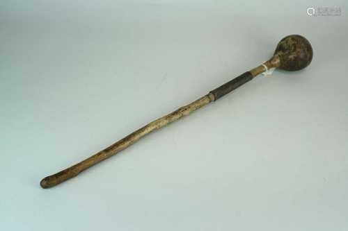 A weathered hardwood knobkerry, the shaft with carved notches and an applied wrythen copper