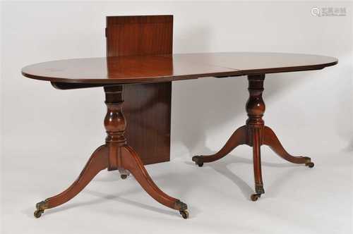 A twin pillar mahogany pedestal dining table