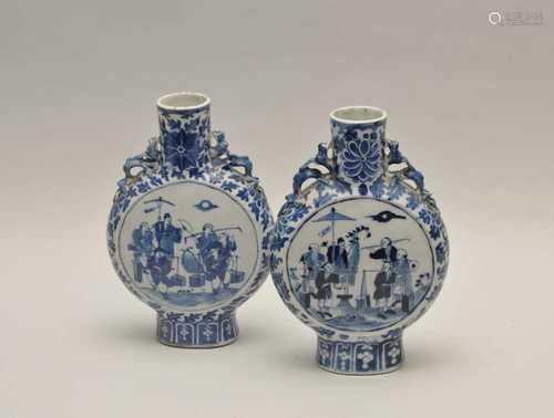 A pair of Chinese blue and white moon flasks, decorated centrally with groups of workers, below