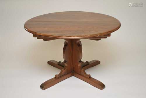 A 20th century Ercol extending dining table, 75cm high, the top measuring 114cm diameter (closed)