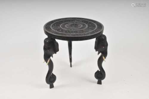 A late 19th / early 20th century Indian carved hardwood table, the circular top decorated
